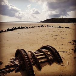 Close-up of sand at beach against sky