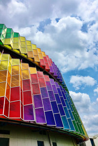 Low angle view of multi colored building against sky