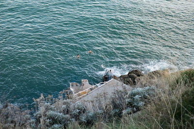 High angle view of people swimming in sea