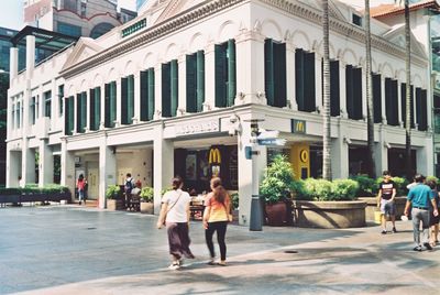 People walking on building in city