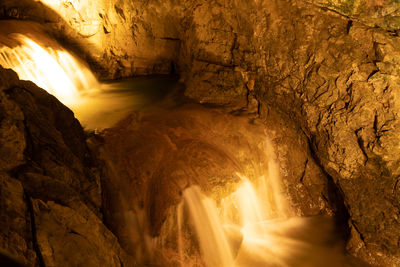 Low angle view of man standing in cave