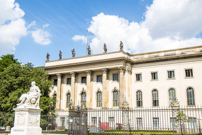 Statue of historic building against cloudy sky