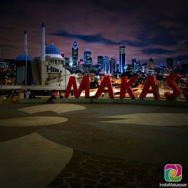 city, building exterior, communication, built structure, sky, architecture, text, guidance, skyscraper, western script, tall - high, tower, cloud - sky, illuminated, outdoors, modern, sign, night, cityscape, no people