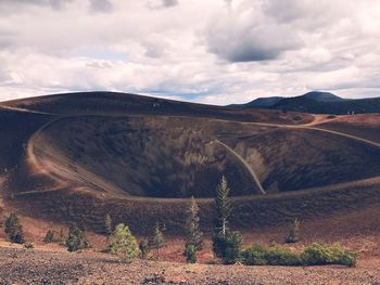 Scenic view of mountain against cloudy sky