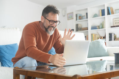 Young woman using laptop at home