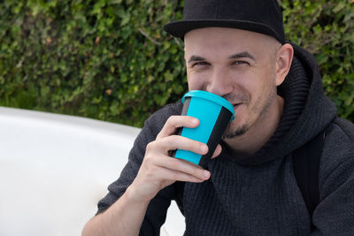 Portrait of man drinking coffee outdoor