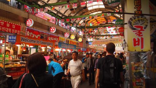 People in illuminated market at night