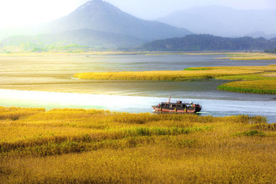 Scenic view of lake amidst field