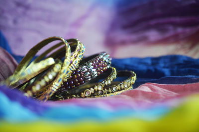 Close up indian bangle jewelry on colourful textiles