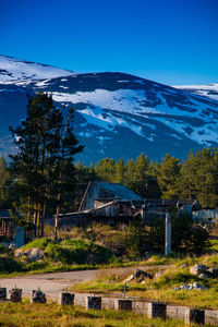 Scenic view of snowcapped mountains against blue sky