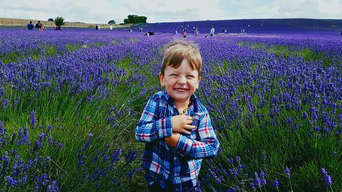 Portrait of smiling boy standing on field