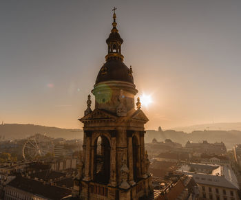 Cathedral in city against sky during sunset