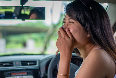 Portrait of woman in car