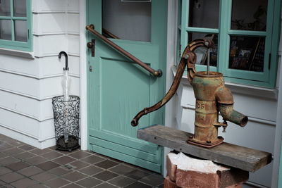 Rusty water pump outside house