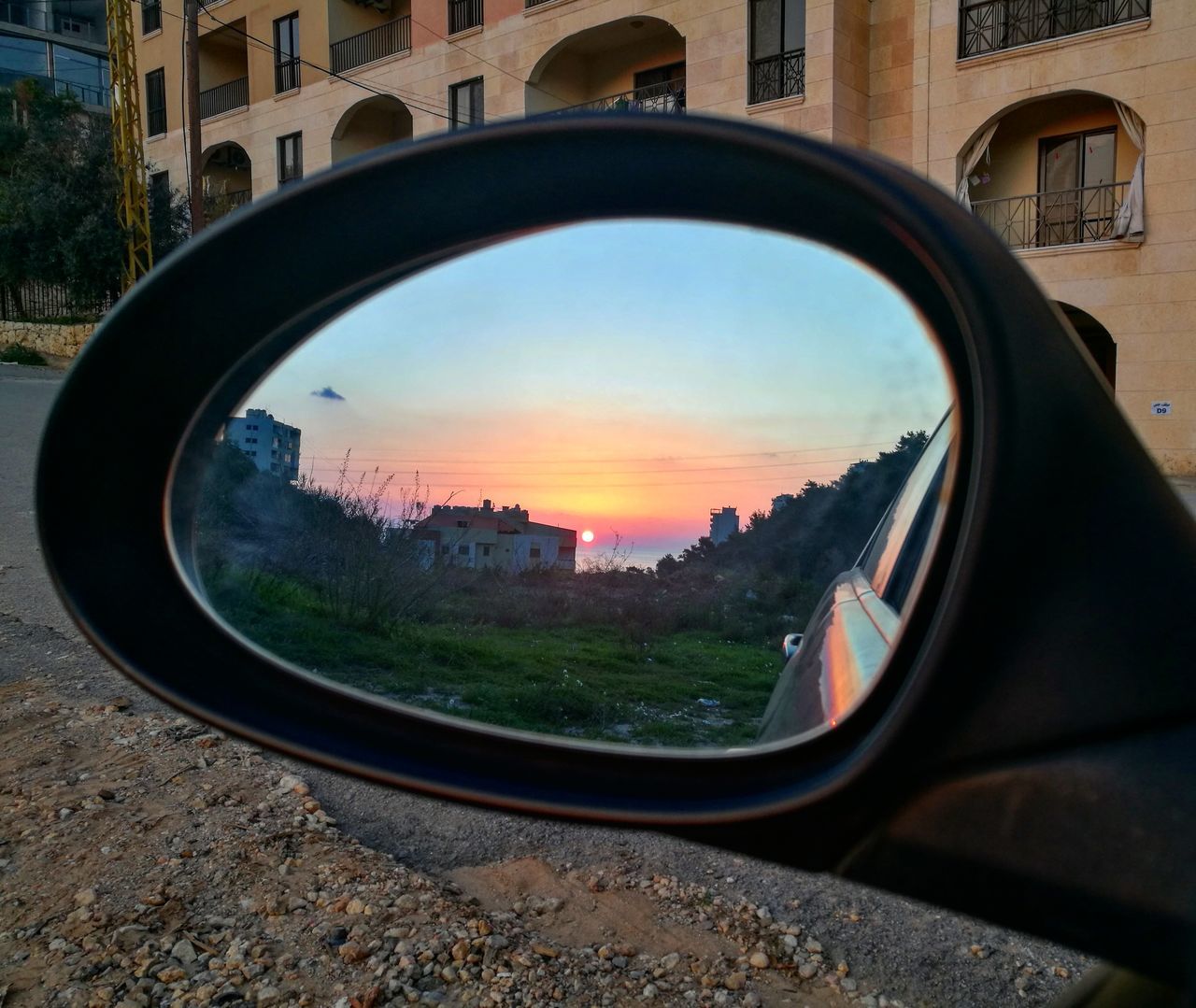 architecture, transportation, built structure, building exterior, side-view mirror, land vehicle, mode of transport, car, no people, road, reflection, outdoors, sky, sunset, close-up, city, day, nature