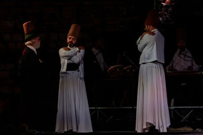 Group of people in traditional clothing at night