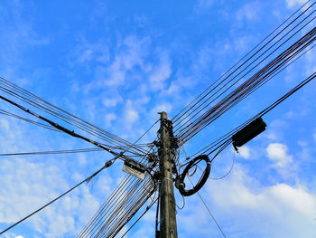 Low angle view of electricity pylon against sky