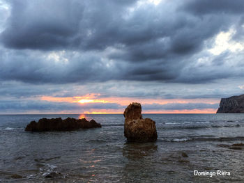 Scenic view of sea against cloudy sky