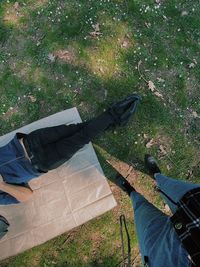 Low section of woman standing on grass