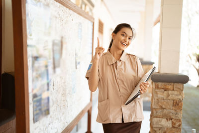 Portrait of young woman using mobile phone