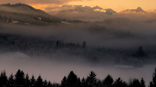 Scenic view of silhouette mountains against sky during sunset