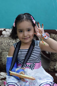 Portrait of smiling girl sitting outdoors