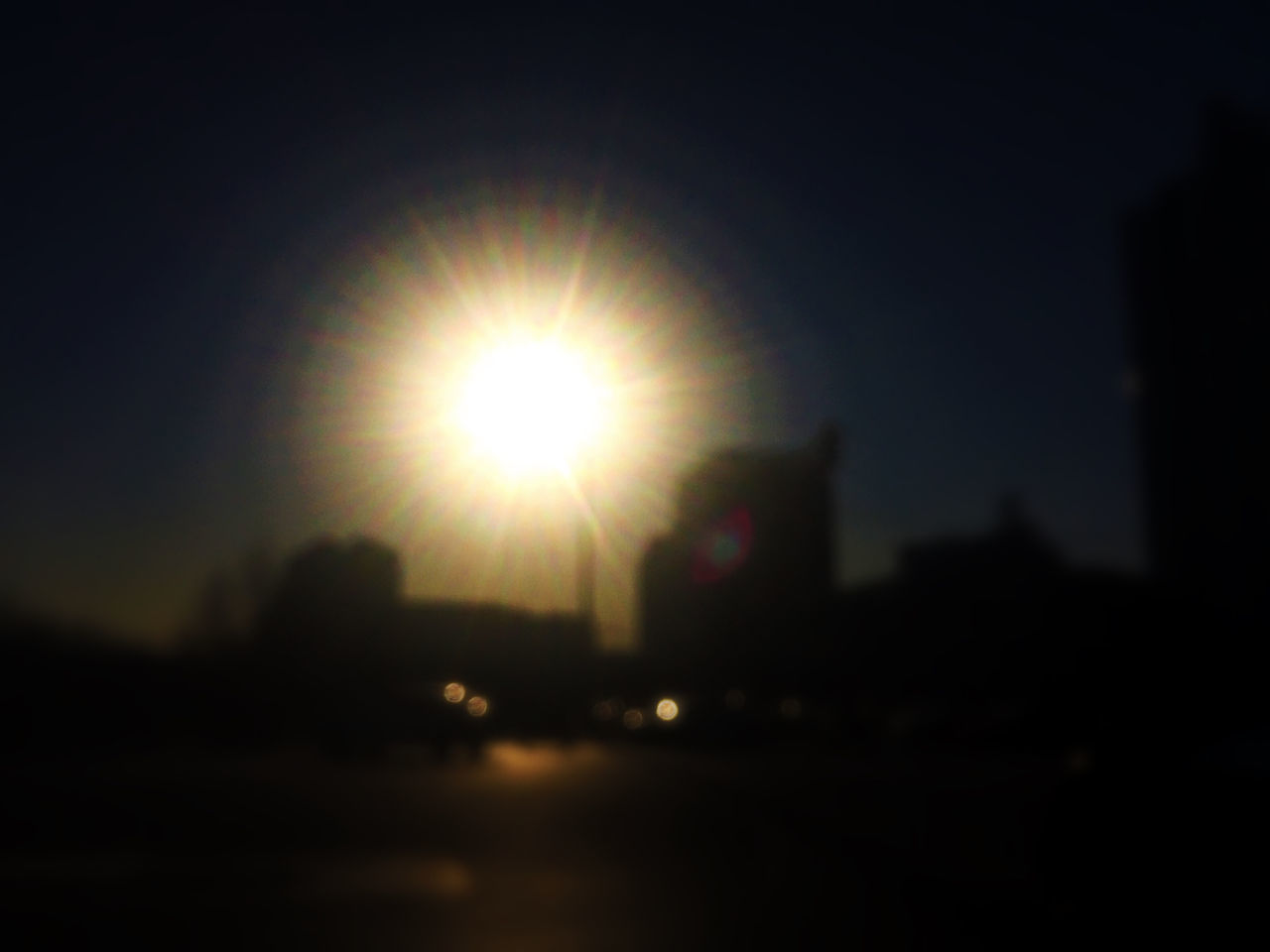 lens flare, sun, silhouette, sunlight, built structure, defocused, illuminated, building exterior, sunset, dark, architecture, sunbeam, night, city, sky, clear sky, no people, outdoors, copy space, street