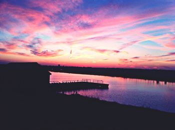 Scenic view of calm lake at sunset