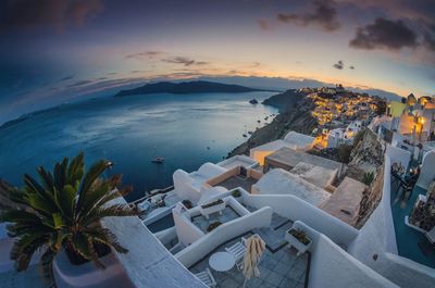 High angle view of buildings by sea during sunset at santorini