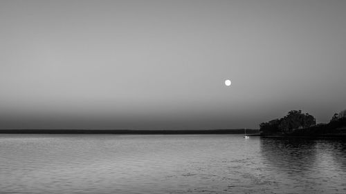 Scenic view of sea against clear sky at night