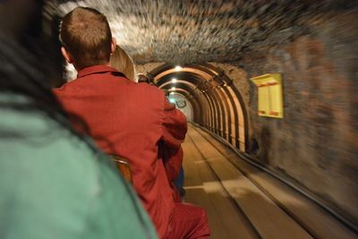 Rear view of people in tunnel