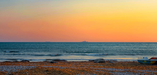 Scenic view of sea against orange sky