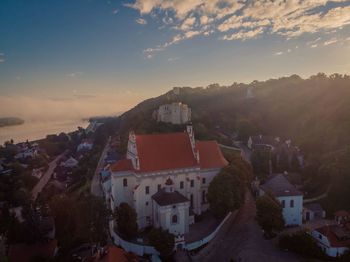 High angle shot of townscape against sky at sunset