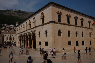 Group of people in front of historical building