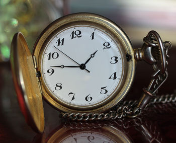 Close-up of pocket watch on table