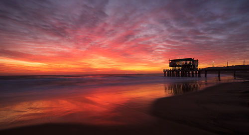 Scenic view of sea against orange sky