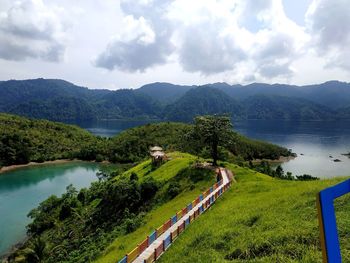 Scenic view of lake and mountains against sky