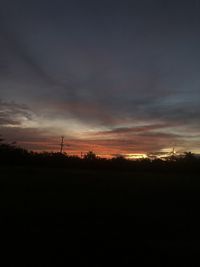 Scenic view of silhouette field against sky during sunset