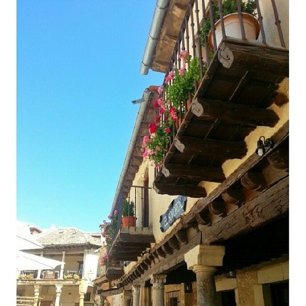 built structure, architecture, building exterior, low angle view, clear sky, blue, day, house, roof, steps, railing, outdoors, residential structure, sunlight, staircase, building, sky, residential building, no people, wood - material