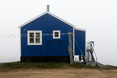 Built structure on beach against clear blue sky