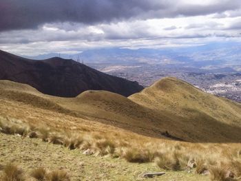 Scenic view of mountains against cloudy sky