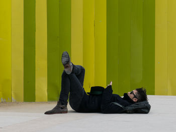 Full length of man sitting on bench