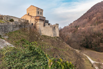 Sunset on the ancient castle of ragogna, italy. fortress guarding the ford on the river tagliamento