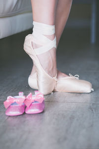 Low section of ballet dancer standing on floor 