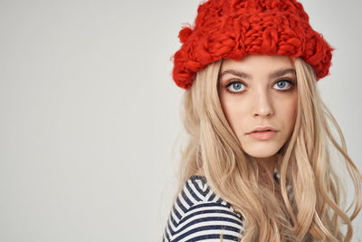 Portrait of woman wearing hat against white background