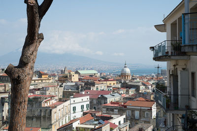 High angle view of townscape by sea against sky