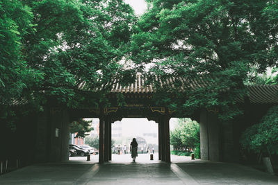 People in park by building