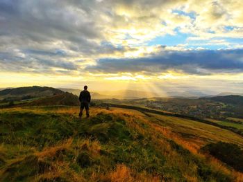 Rear view of man looking at sunset