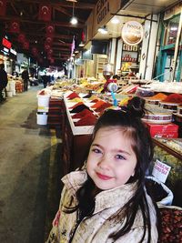 Portrait of smiling girl standing outdoors