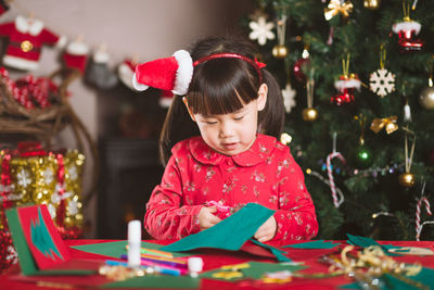 Girl looking at christmas tree